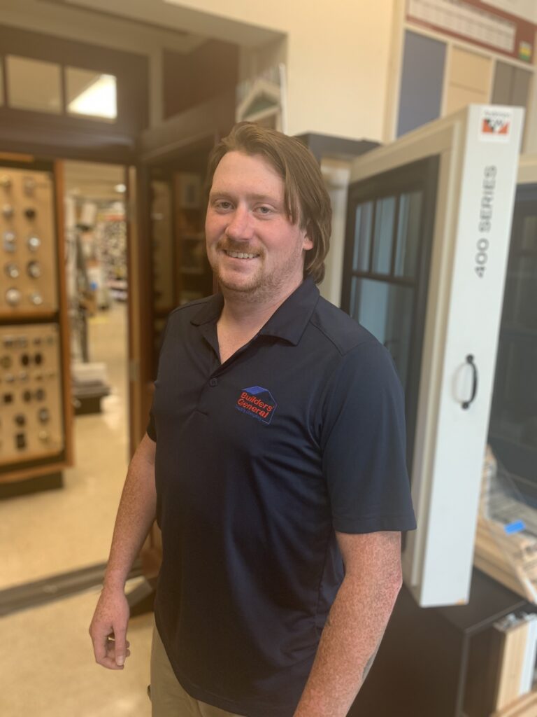 Dan Pollard, Dispatcher at Builders' General Little Silver location, standing inside the store. Home building supplies can be seen in the background.