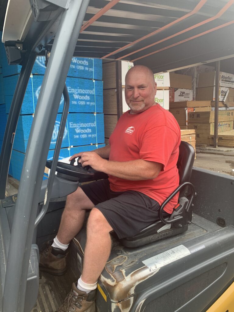 Builders’ General's employee driving a forklift at Builders’ General Little Silver location